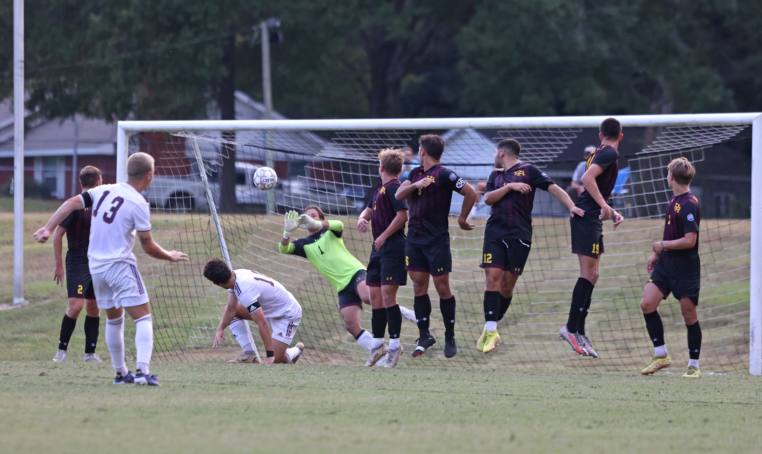 Maddux Francis (Poplarville) dives to his right to make a save on a free kick. (Matthew Alford/Hinds Athletics)