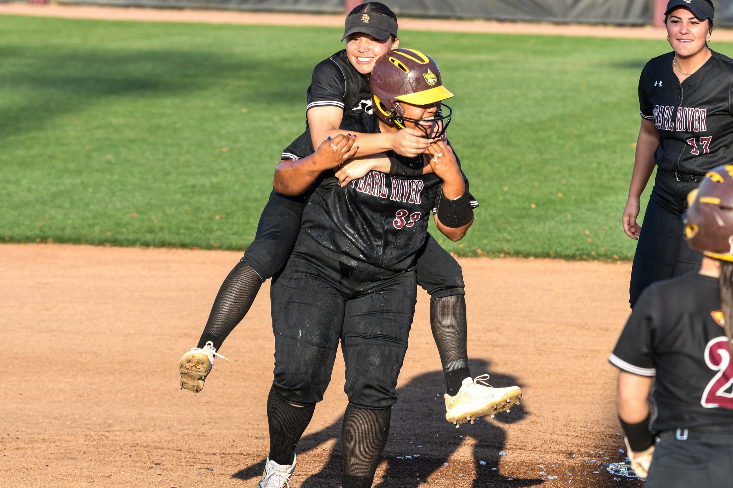 Maeli Ben (Conehatta; Newton County) celebrates with teammates after delivering a walk-off RBI single to beat North Iowa Area 5-4. (Grace Kesler)